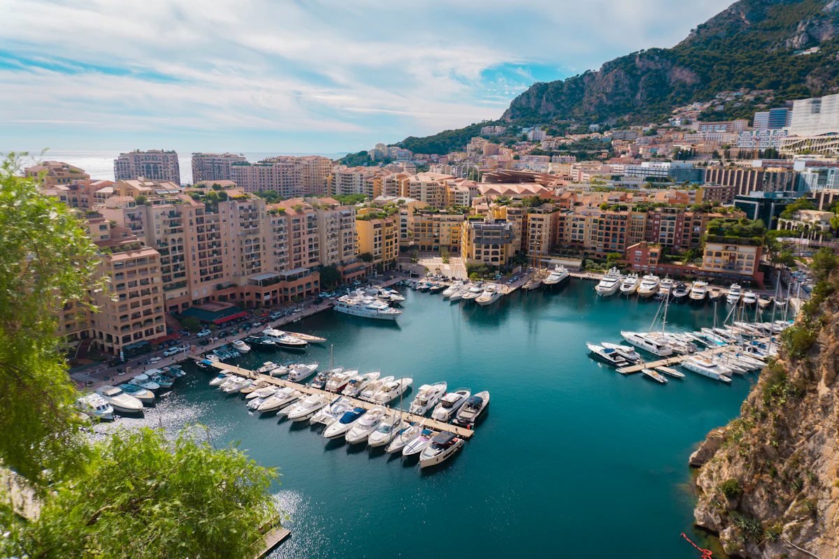 Yachts moored in a Mediterranean harbour beneath the city
