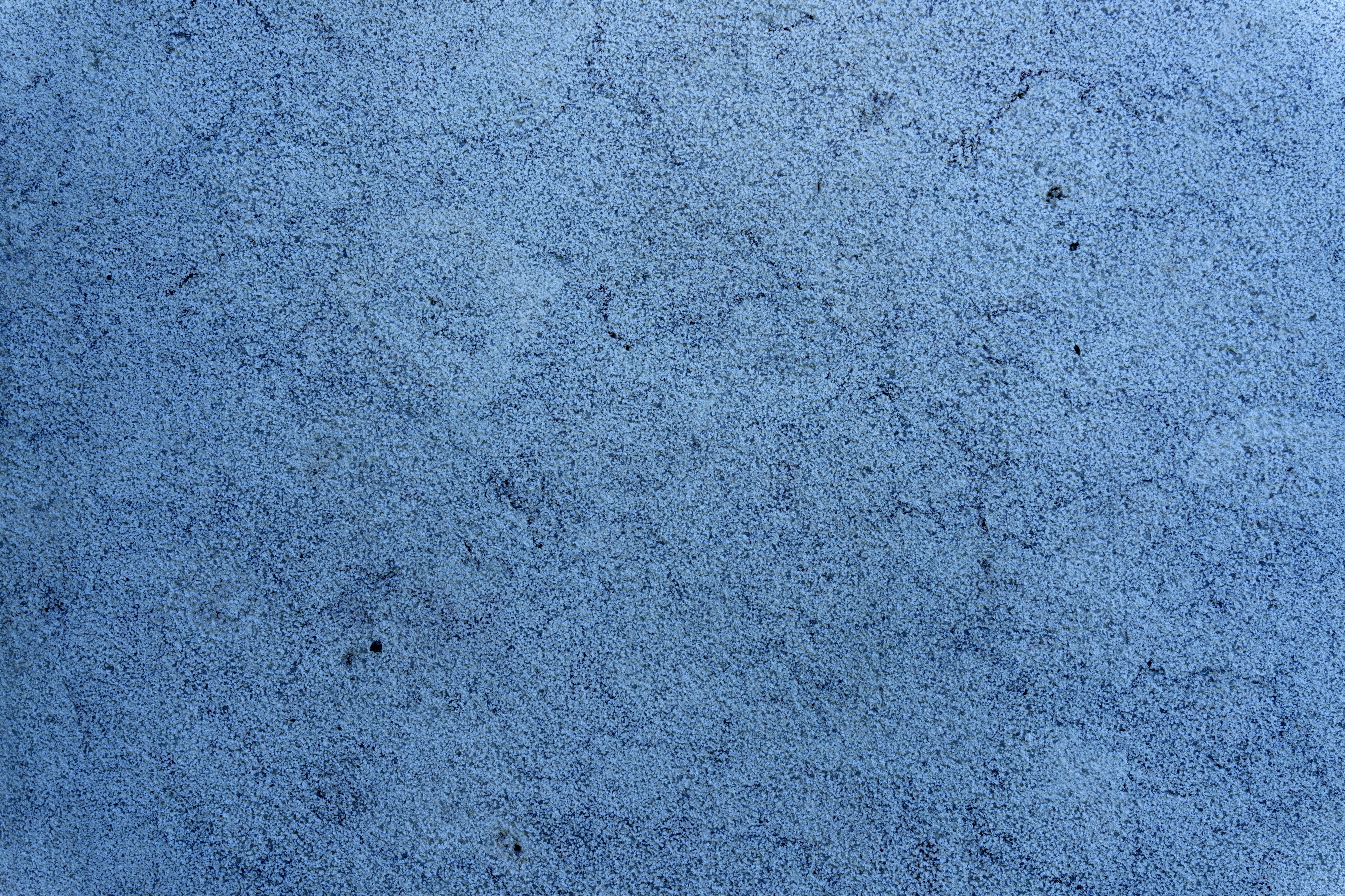 A textured blue concrete background