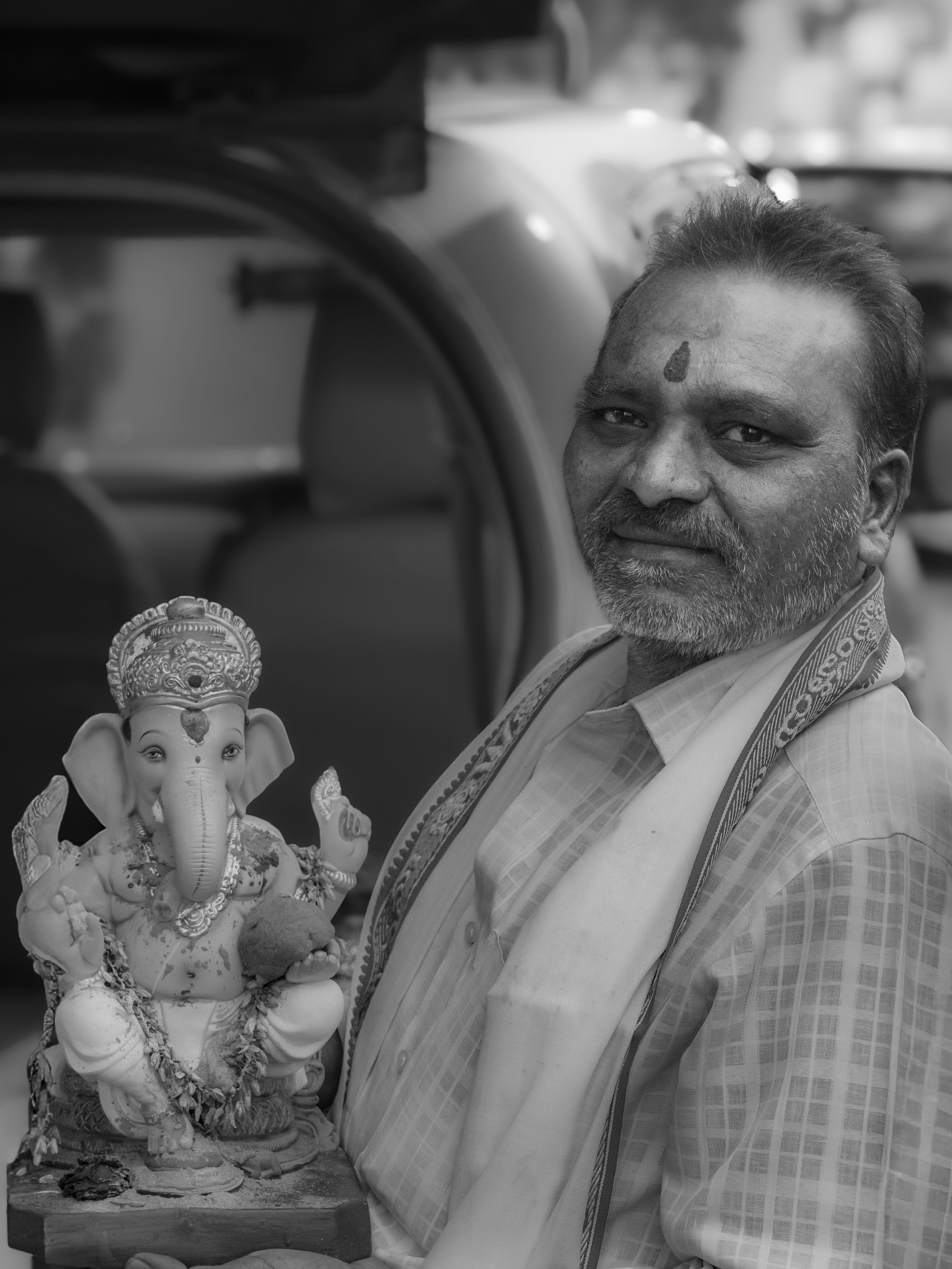 Man holding a ganesha statue
