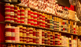 Rows of colorful bangles and bracelets displayed on shelves.