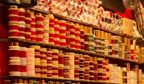 Rows of colorful bangles and bracelets displayed on shelves.