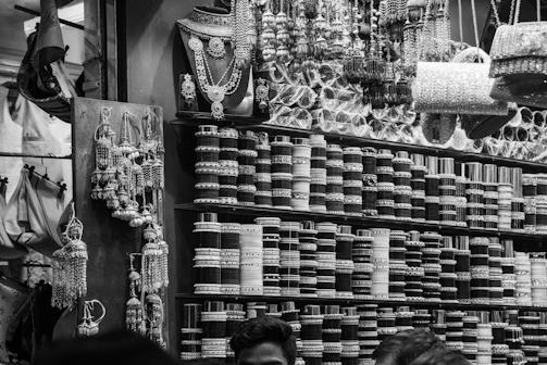 Shelves filled with bangles and jewelry at a market.