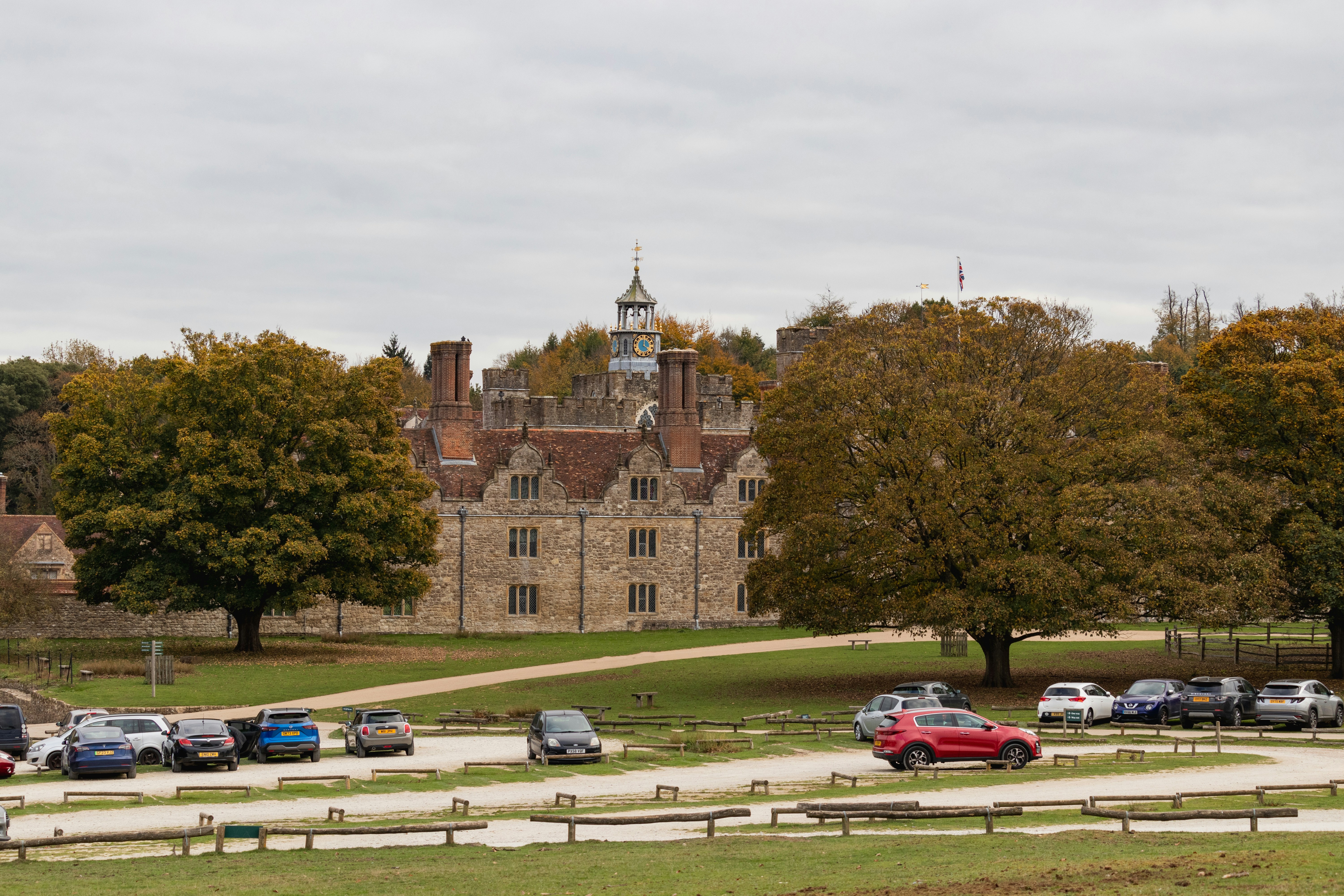 Historic building with a parking lot and trees.