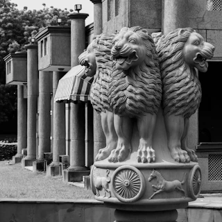 Four lions atop a pillar with wheels and animals