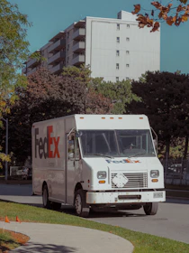 White fedex truck parked on a street.