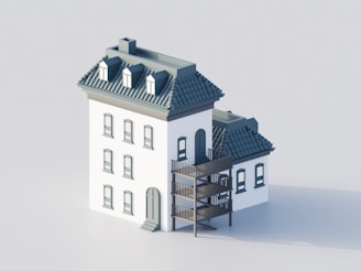 A white building with a dark roof and balconies.