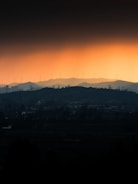Silhouetted hills and wind turbines at sunset