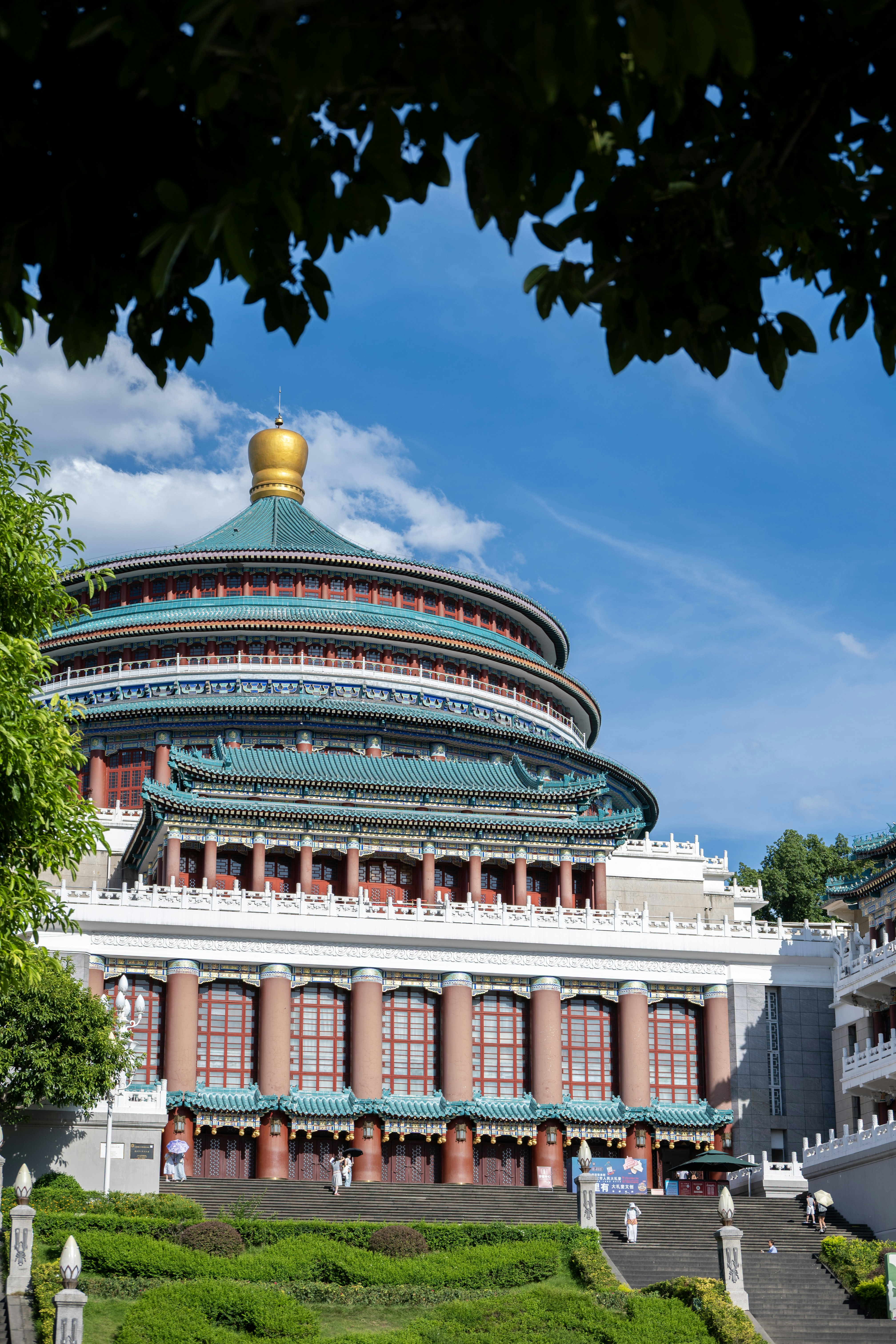 Grand building with tiered roofs and golden dome.