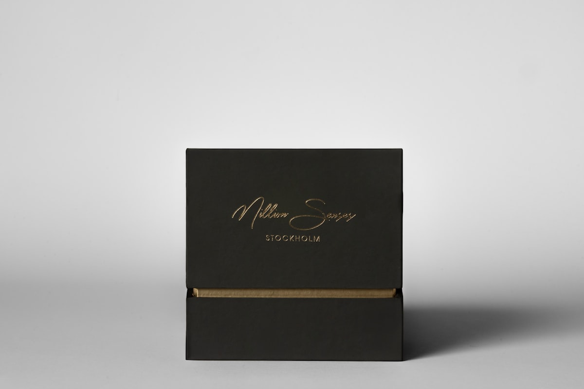 Elegant black rigid gift box with gold lettering displayed on a clean white background