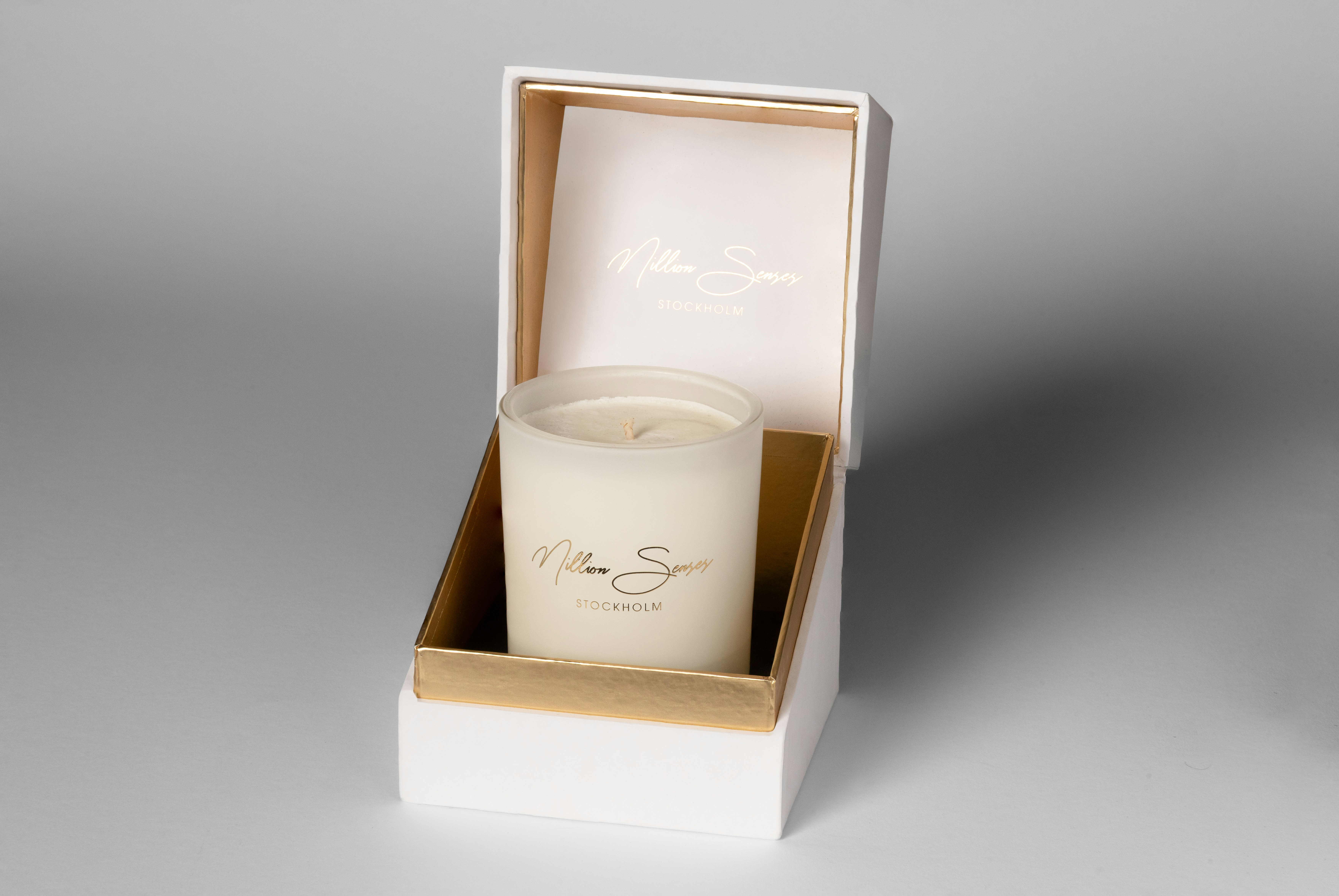 White candle in an open gift box