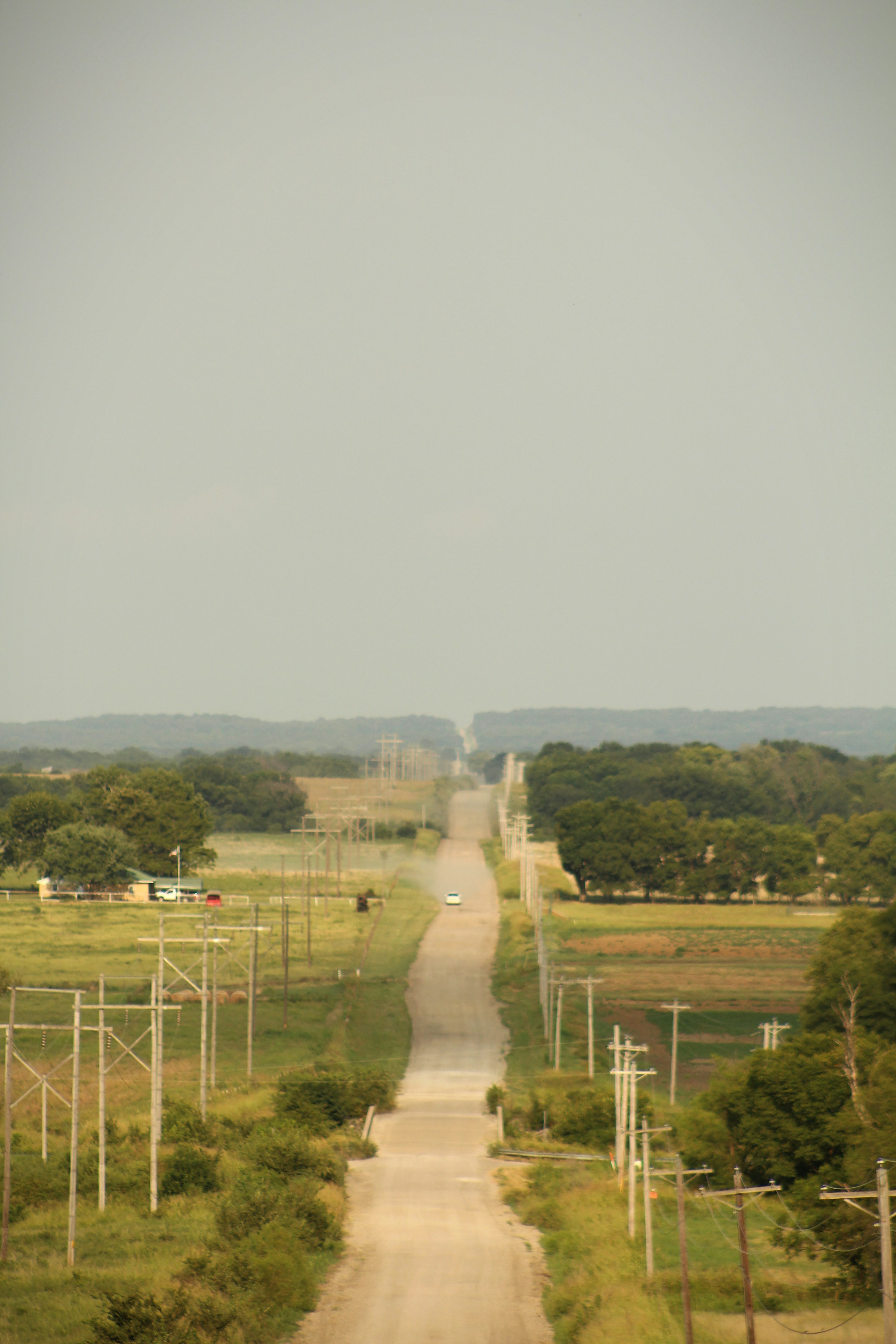 Long, empty dirt road stretching to the horizon