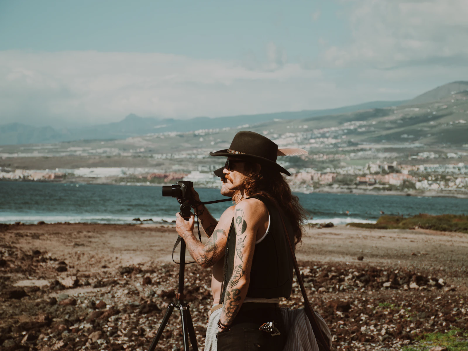 A camera on a tripod set up above the sea, waiting for the light
