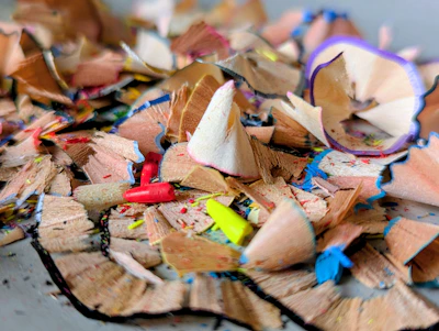 Pile of colorful pencil shavings and broken crayons.