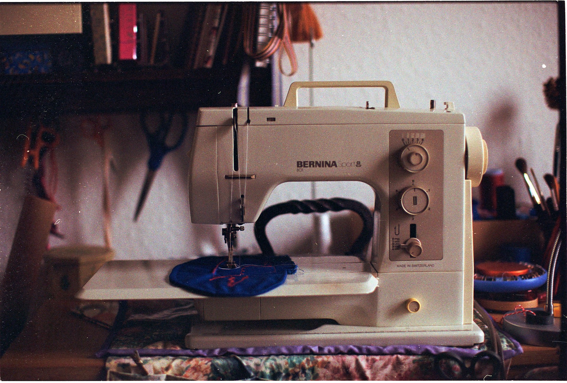 A vintage sewing machine with fabric on the needle.