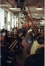 Rows of industrial looms in a workshop.