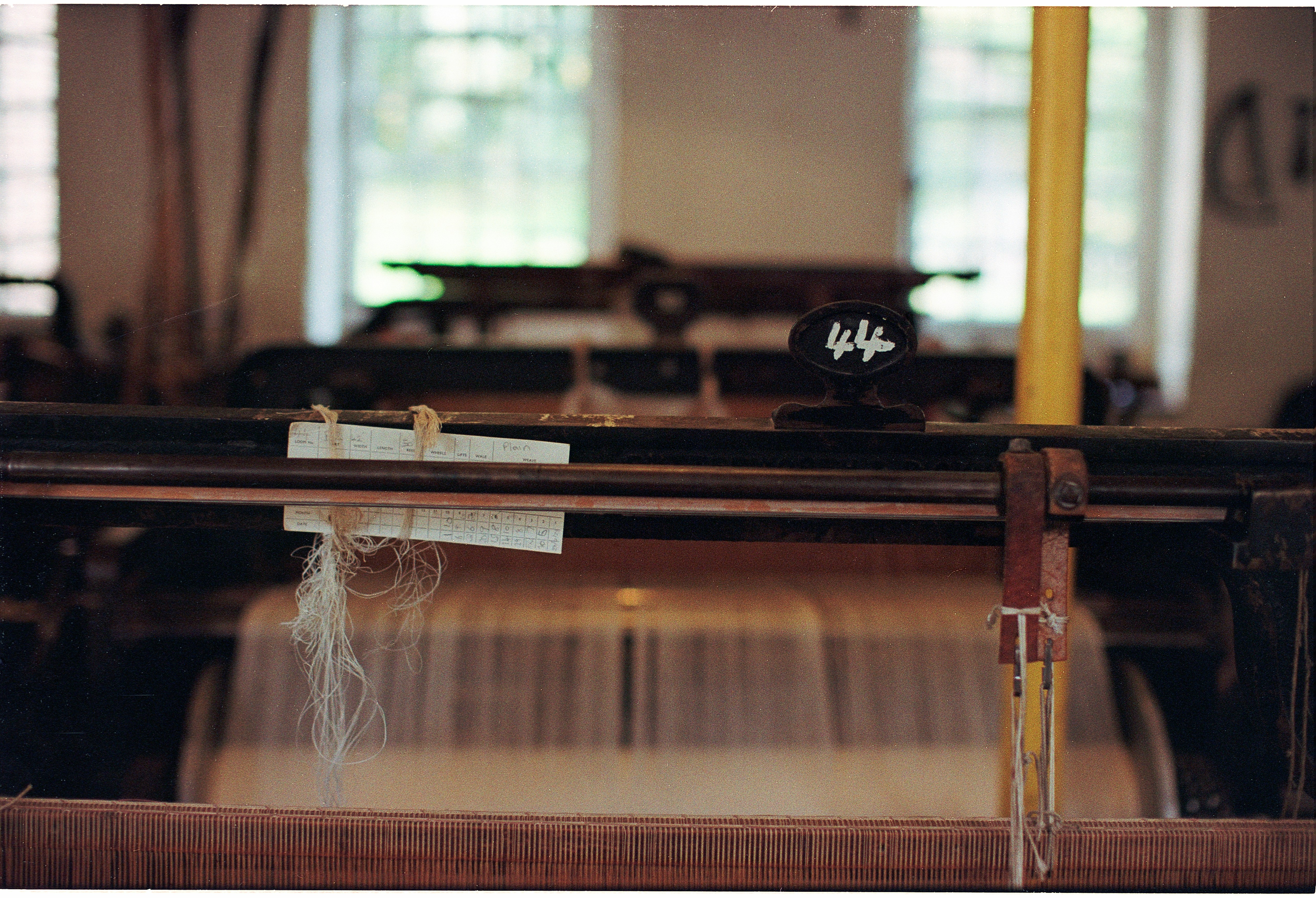 Old loom with threads in a workshop.
