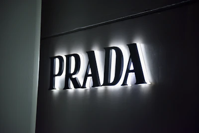 Illuminated prada logo on a dark wall