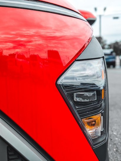 Close-up of a red car's headlight