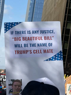 Protest sign with text about trump and justice.