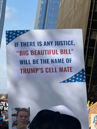 Protest sign with text about trump and justice.