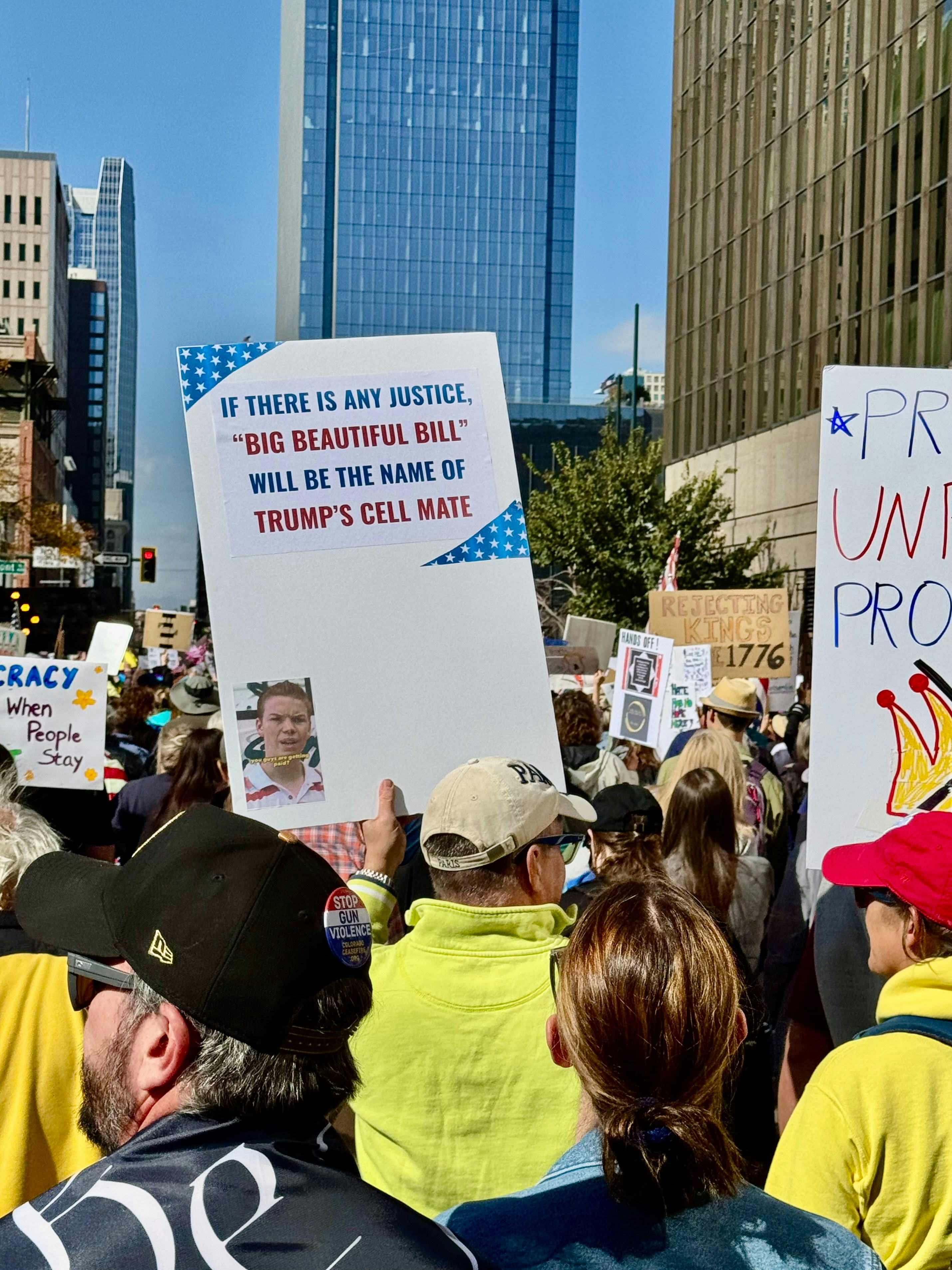 Protestors hold signs in a city street.