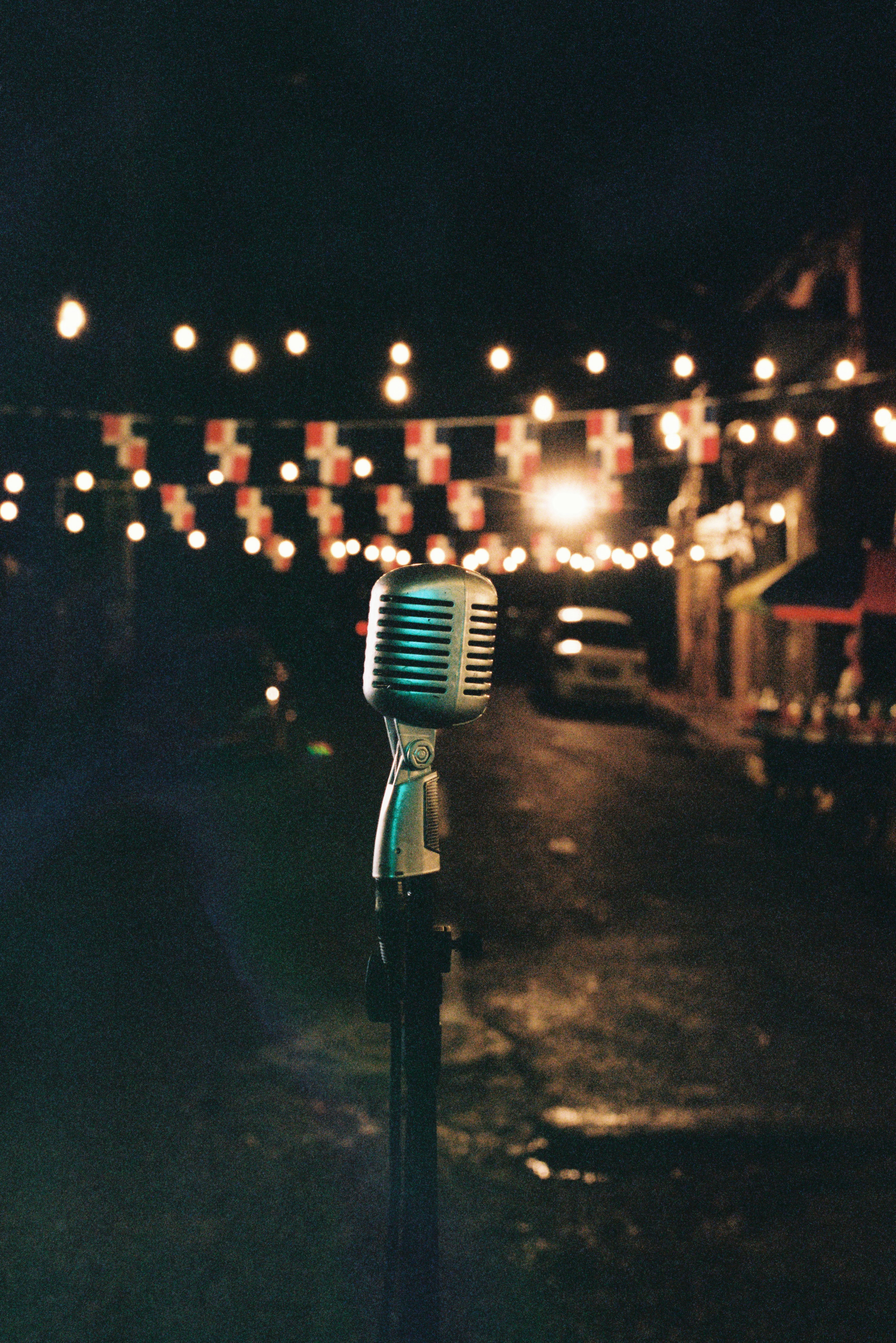 Vintage microphone on stand with string lights