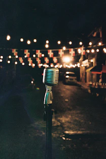 Vintage microphone on stand with string lights