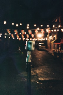 Vintage microphone on stand with string lights