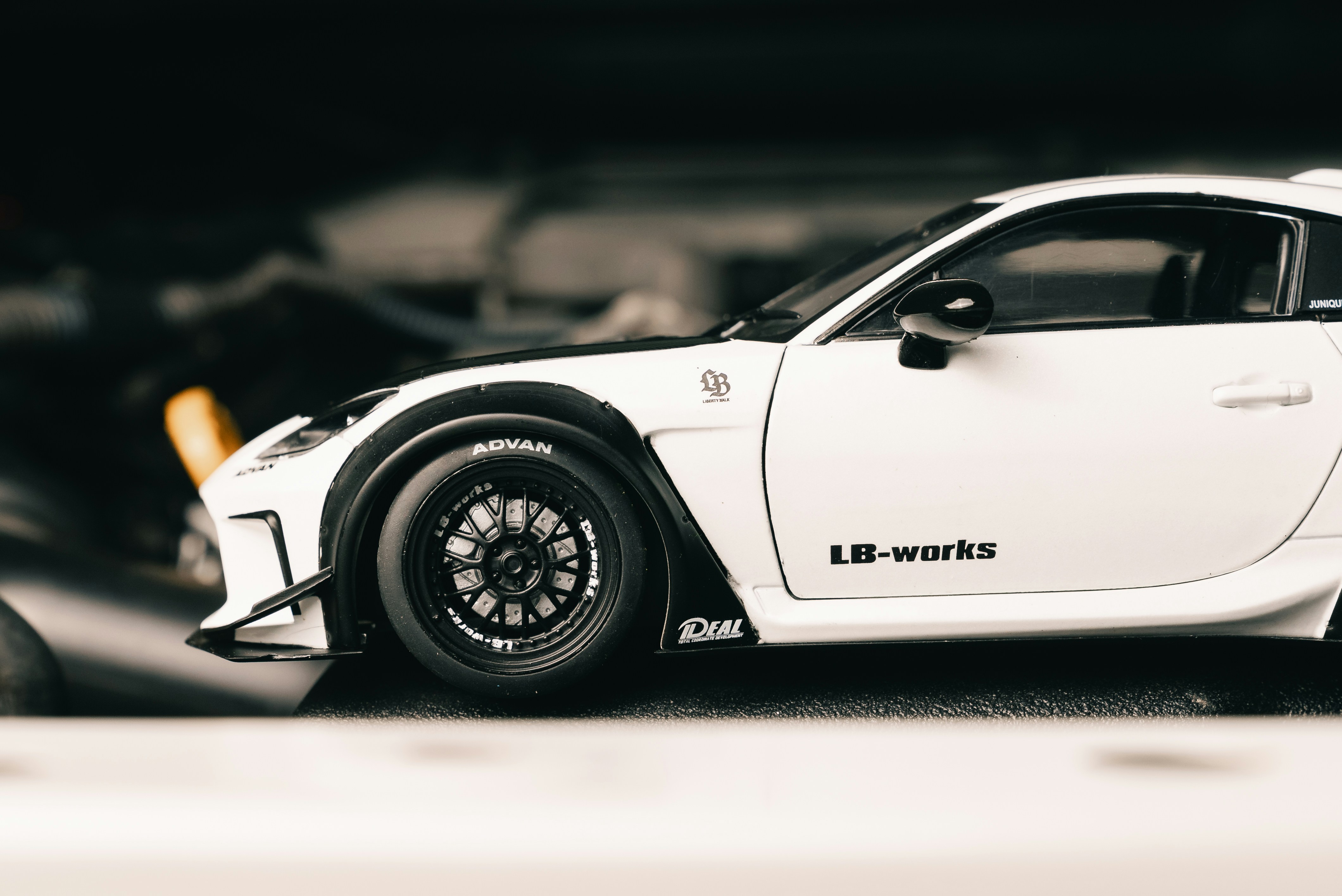White sports car with black accents and silver wheels.