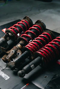 Set of four coilover assemblies on workbench