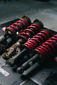 Set of four coilover assemblies on workbench