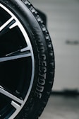 Close-up of a wet bridgestone tire on a car wheel.