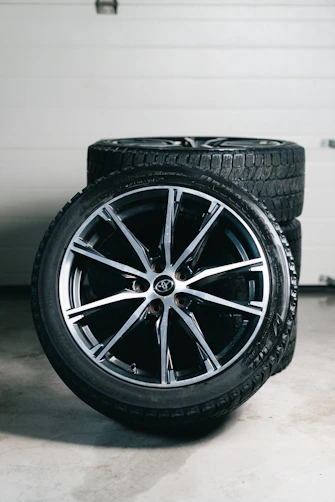 Stack of car wheels and tires in garage