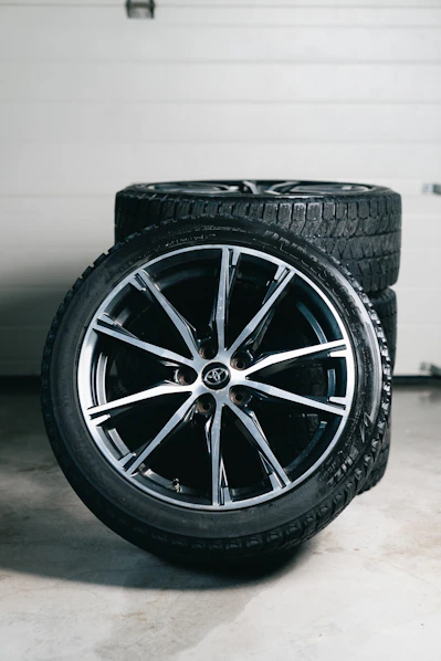Stack of car wheels and tires in garage