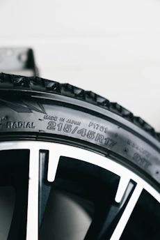 Close-up of a car tire with size information.