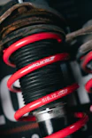 Red coilover suspension with brand name visible