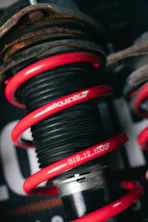 Red coilover suspension with brand name visible