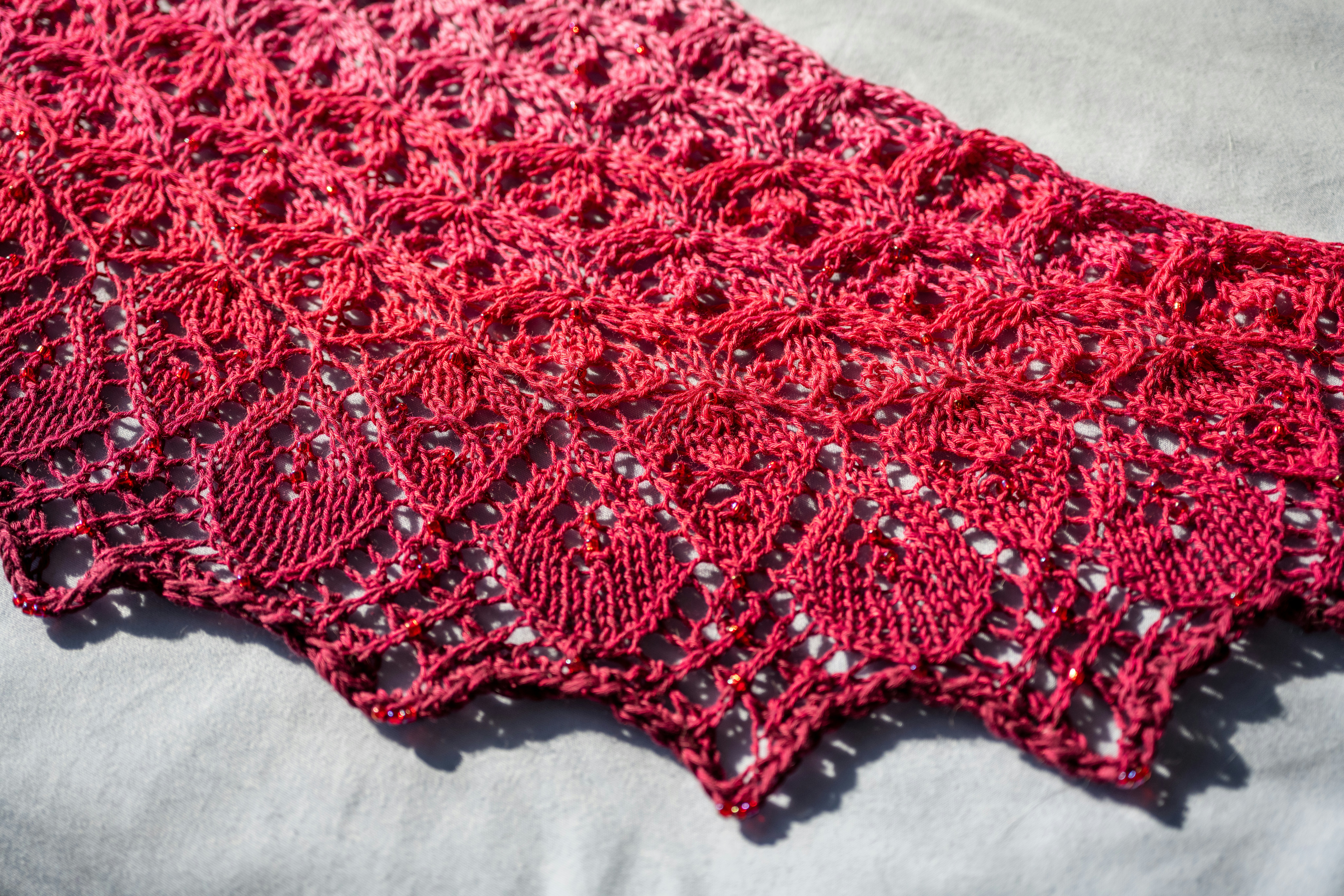 Red knitted lace shawl with ombre effect