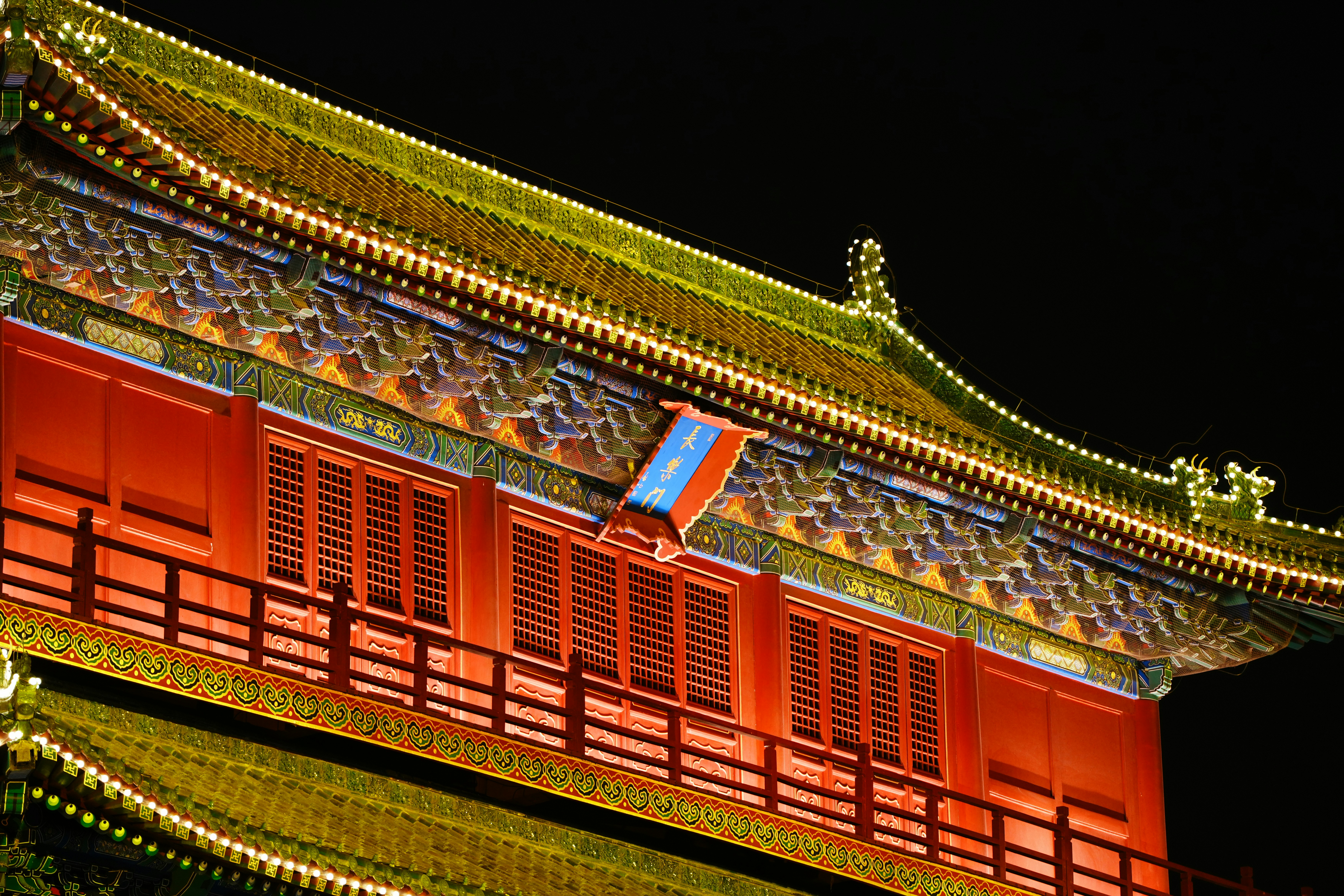 Ornate building with red walls and yellow lights at night