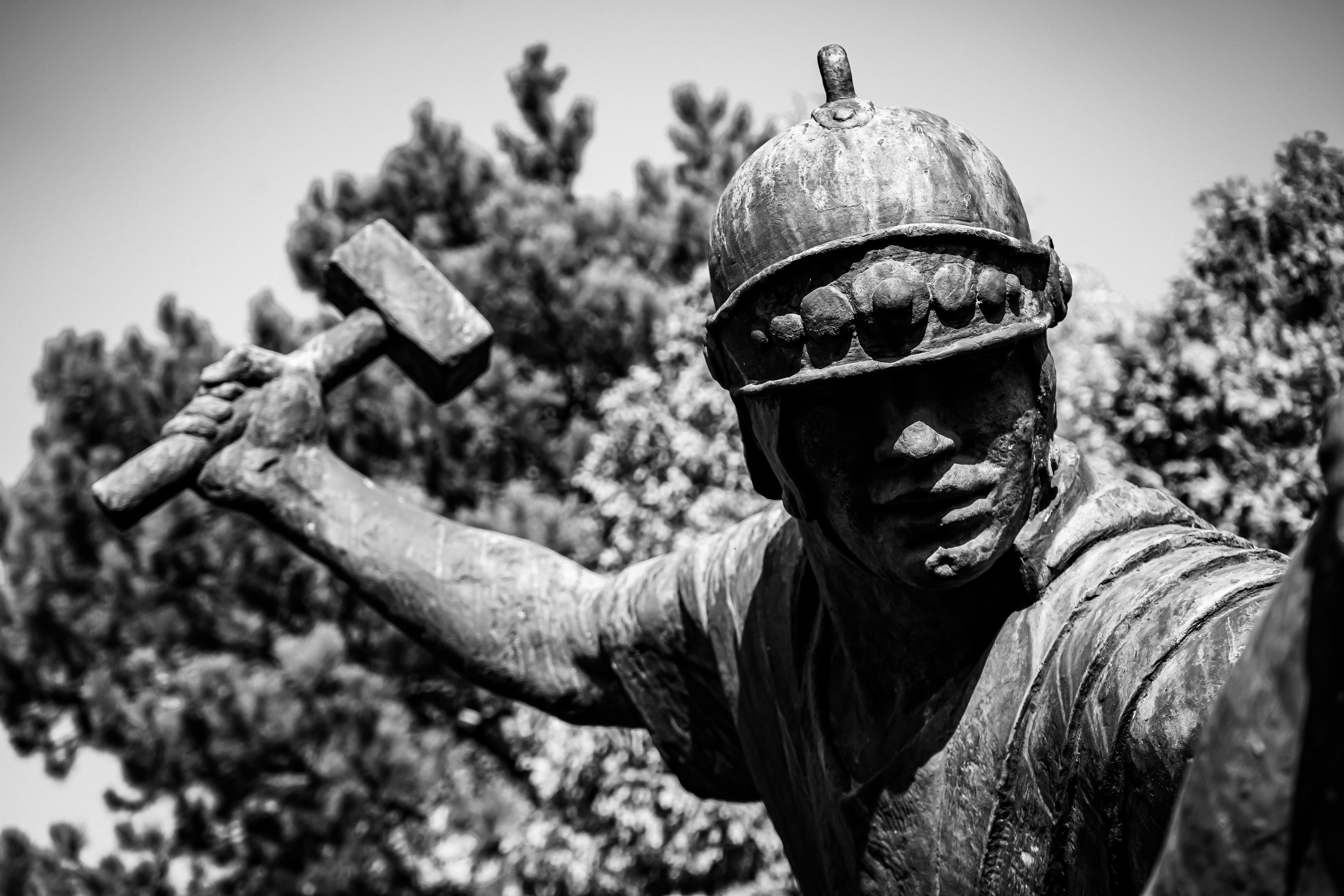 Bronze statue of a soldier holding a hammer