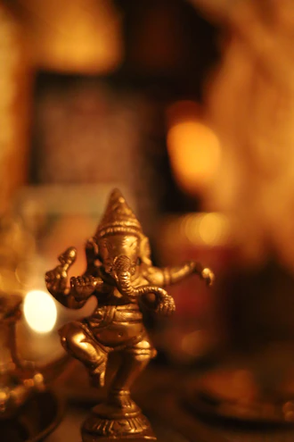 A small brass statue of the hindu deity ganesha.