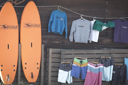 Surfboards and apparel displayed outside a shop.