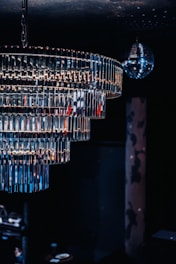 A multi-tiered crystal chandelier with a disco ball.