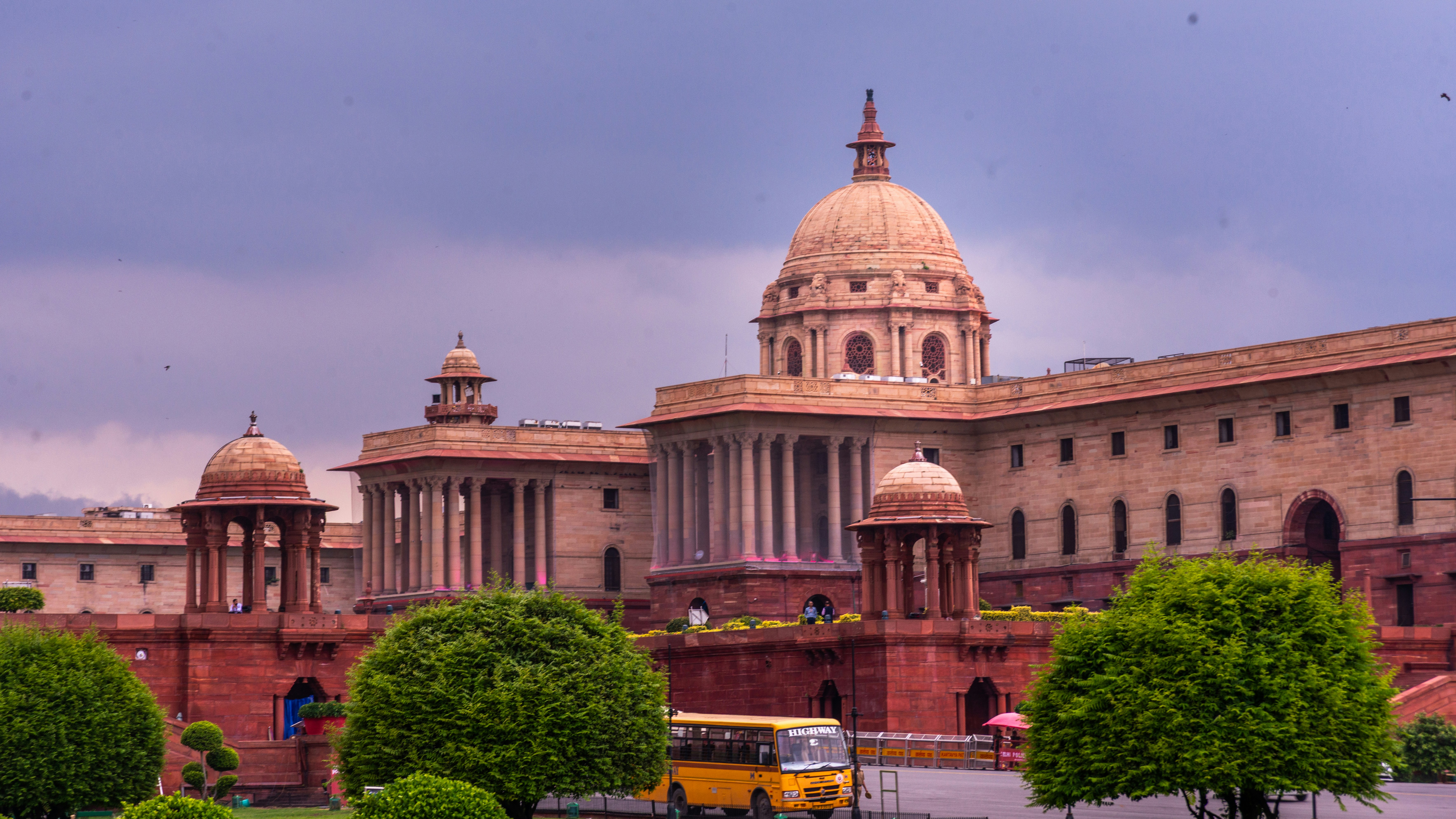 Grand building with domes and manicured gardens