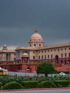 Grand building with dome under cloudy sky