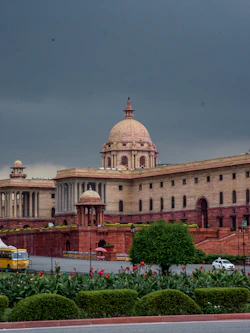 Grand building with dome under cloudy sky