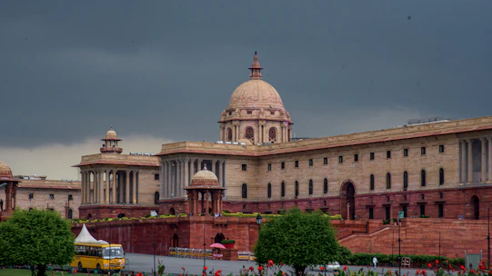 Grand building with dome under a cloudy sky