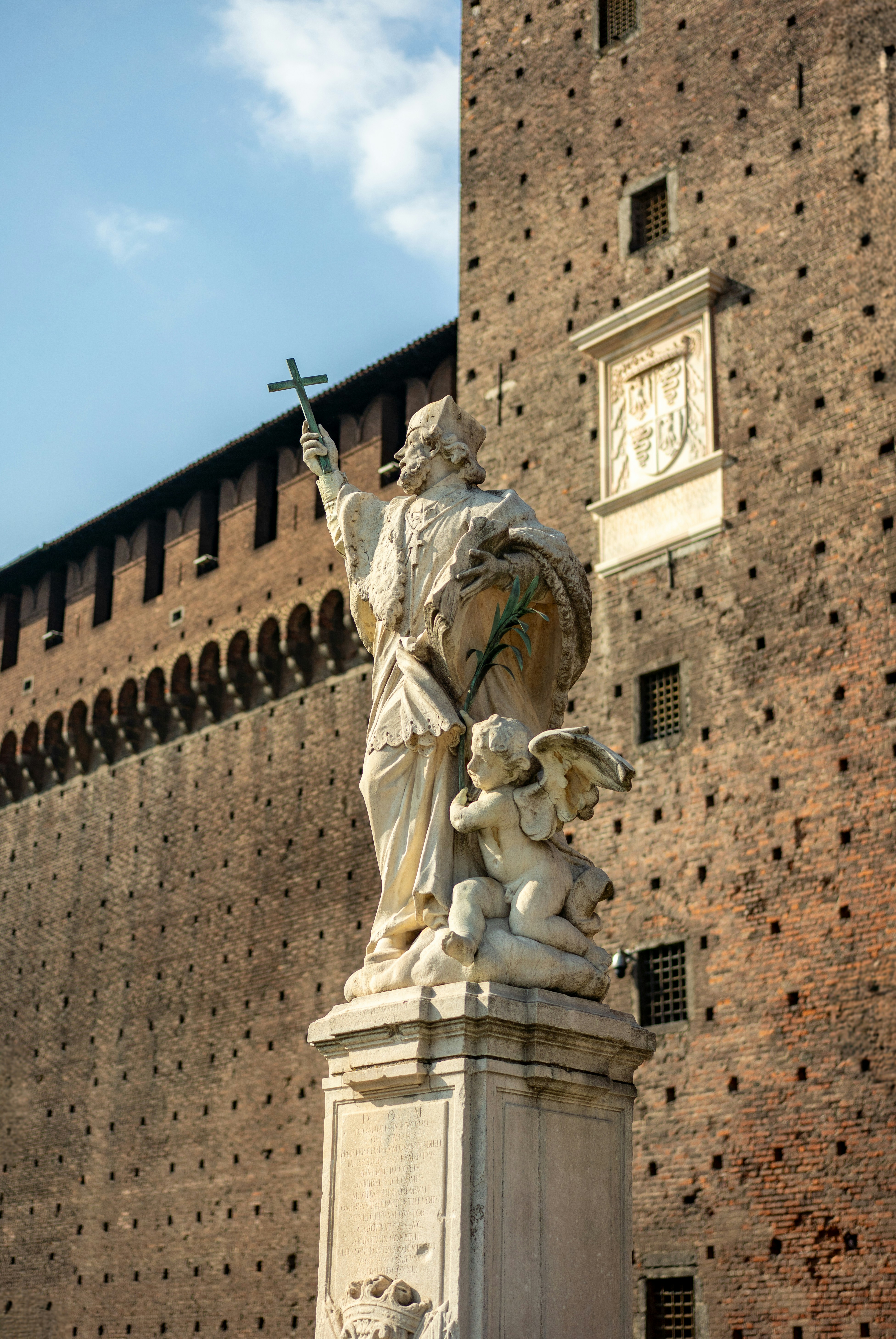 성 앞에 천사와 함께 성인의 동상