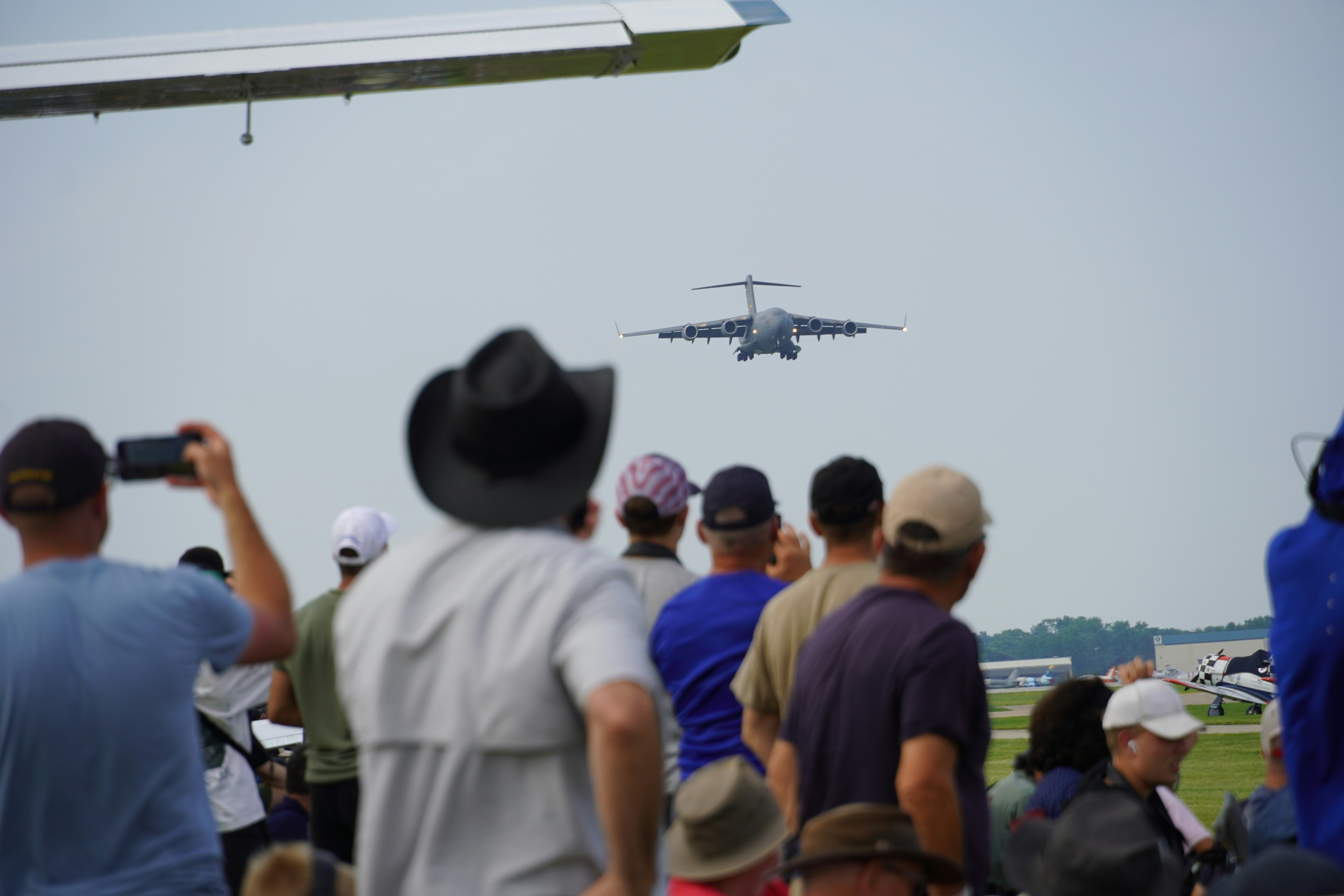 Airplane landing at an airshow with spectators watching