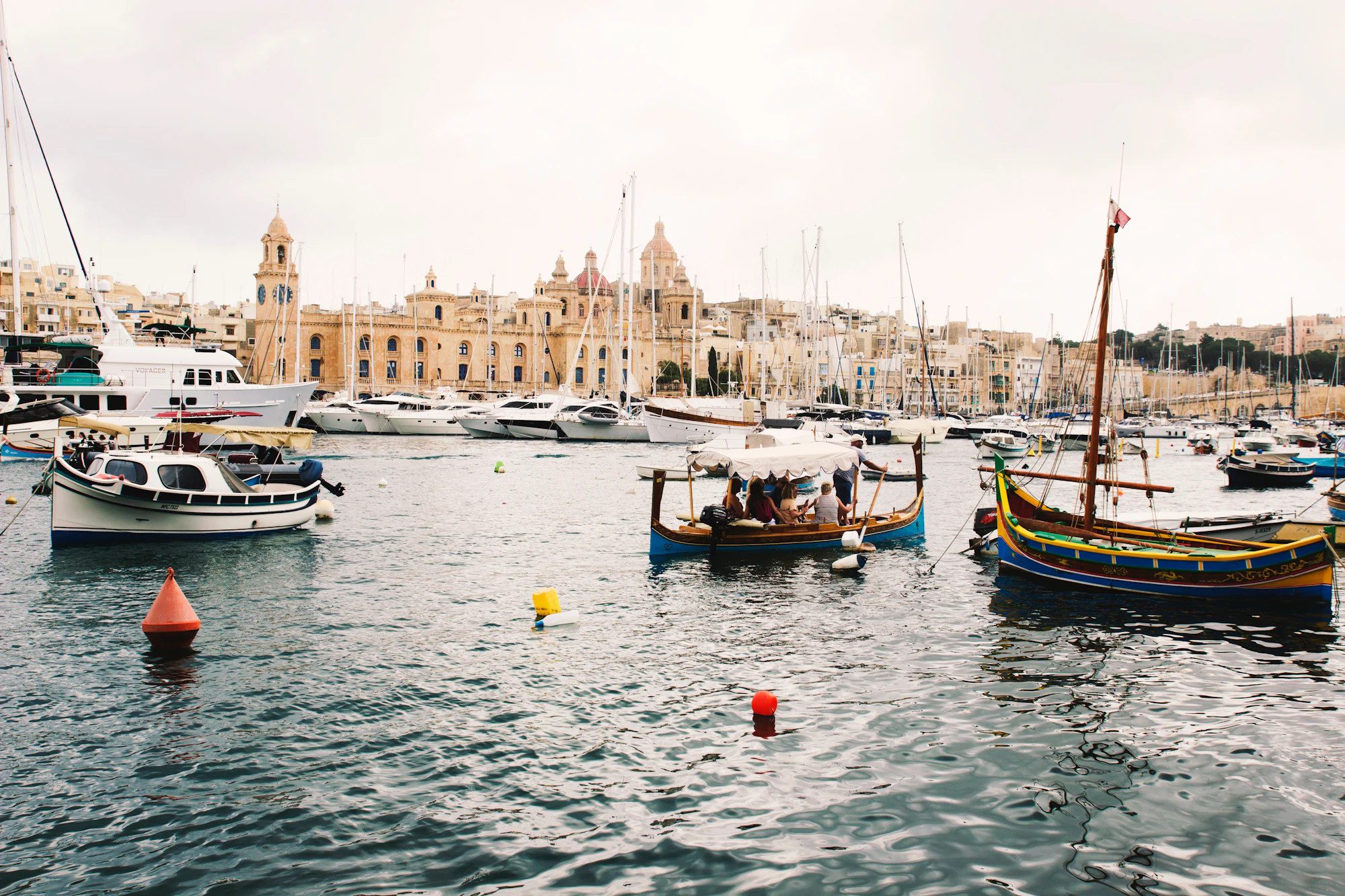 Painted luzzu fishing boats moored in Marsaxlokk harbour